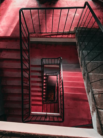 Black Metal Handrails on Red Concrete Stairs